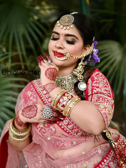 This photo captures the joy of a bride on her special day. The heavy bangles and intricate henna are perfectly complemented by the rental jewellery set.