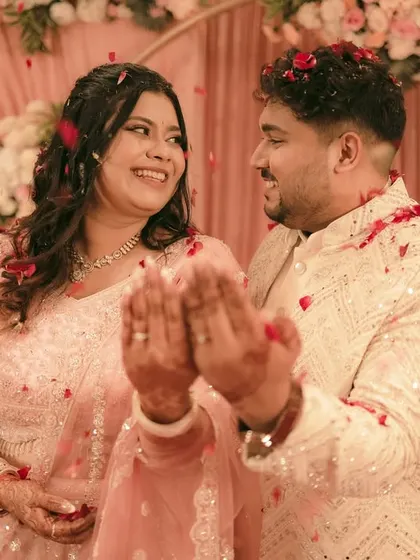 The couple's happy reaction after the ring exchange, their hands joined together.