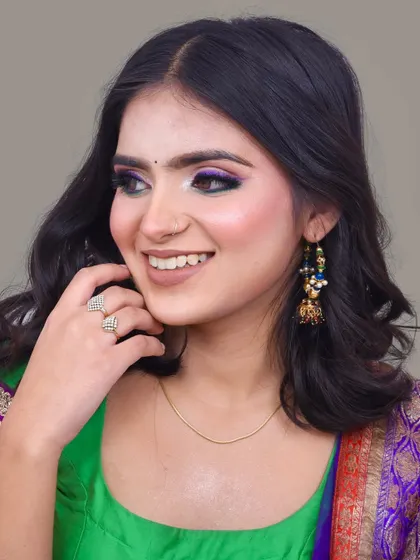 A happy and confident client, ready to attend a wedding. The makeup is designed to last all day and look great in photos.