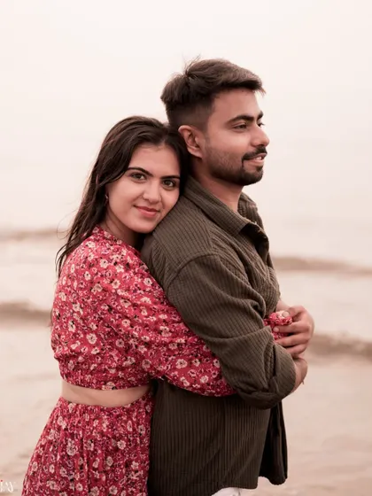 A sweet and gentle hug from behind, showing the comfort and love the couple shares.