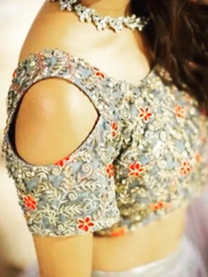 Cold-shoulder sleeves with detailed embroidery are a stylish and modern option for any lehenga or saree blouse. I ensure the cutout and fit are perfect.