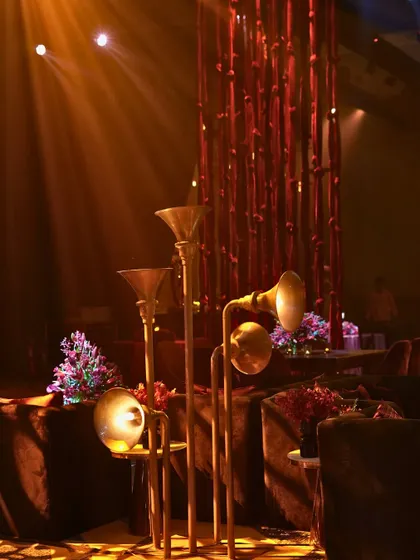 Custom-designed floor lamps resembling vintage gramophones added a quirky, musical touch to the decor.