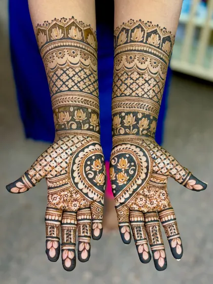 A top-down shot of Supriya's engagement mehendi, showing the symmetry and complexity of the full design.