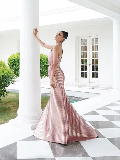 This angle highlights the sleek, body-hugging fit of the metallic pink Amit Aggarwal gown. My focus is always on "Fit > Label," ensuring the silhouette is perfect for the client.