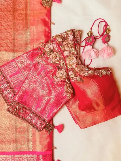 A pink blouse with 3D floral embroidery, paired with a matching saree.