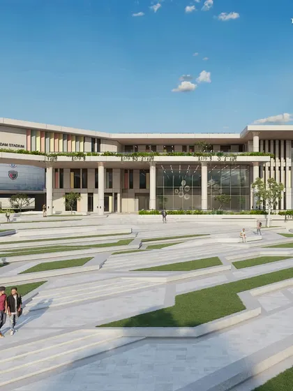 A ground-level perspective of the plaza, highlighting the grand scale of the university's cultural and convention centers. The entire 70-acre master plan aims to unify the campus into a coherent and modern environment.