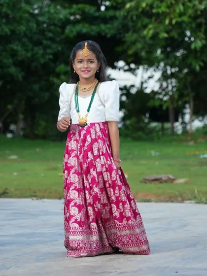 Elegance in every detail. This client is wearing a custom Langa Voni with a white puff-sleeve blouse and a rich pink brocade skirt. It's a classic South Indian look, tailored perfectly for her.