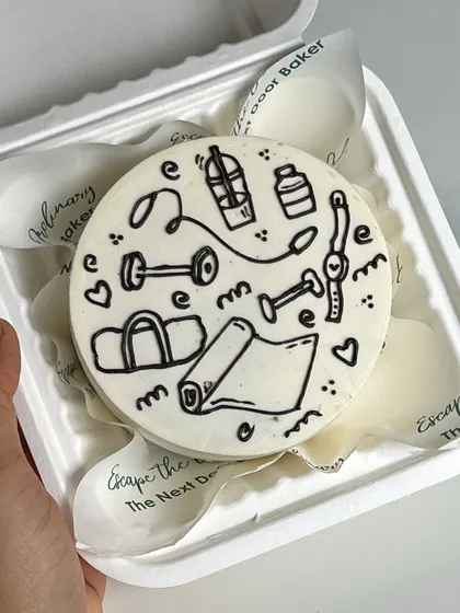For the fitness enthusiast in your life. This mini cake is doodled with all things gym-related, from dumbbells and yoga mats to protein shakes. It's a fun way to celebrate their passion.