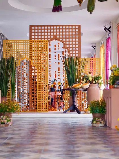 A corridor of joy. We lined the walkway with marigolds and used 'bandhani' print drapes to create a vibrant and traditional passage for guests, setting the perfect tone for a Rajasthani Haldi.