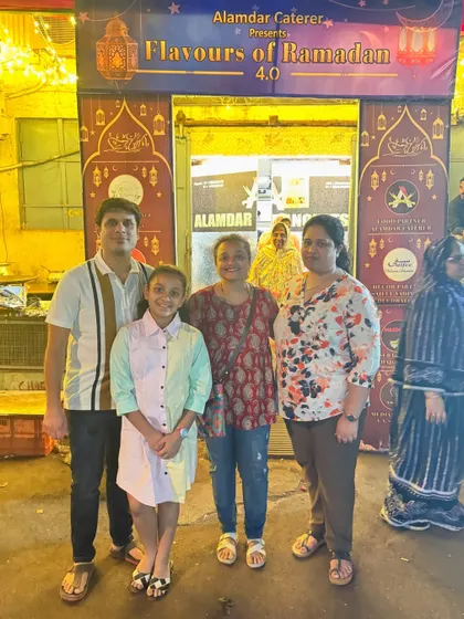 A family poses for a picture at our entrance. We hope you had a delicious and memorable Iftar with us.