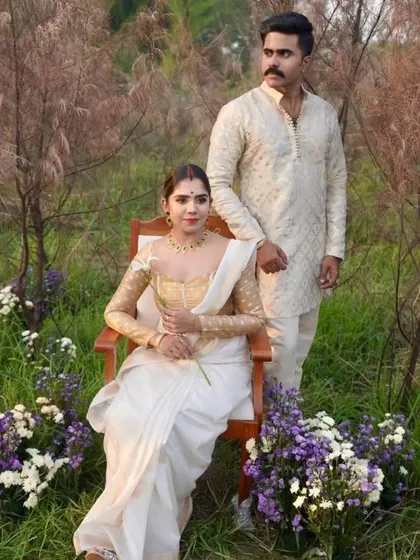 A serene shot from the same outdoor couple shoot, with the groom styled in a traditional kurta.