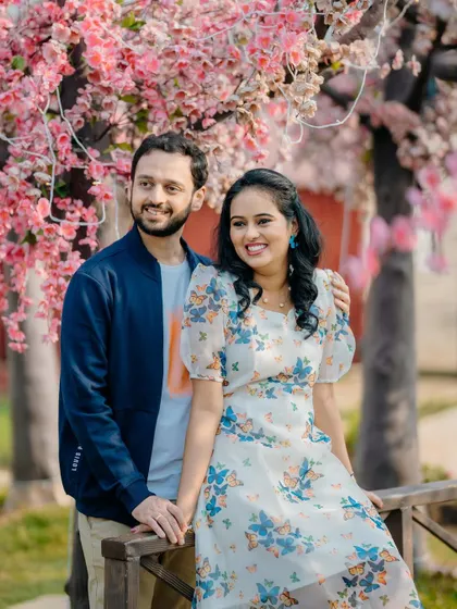 A sweet and casual portrait of Sayali and Siddhesh. The soft pink blossoms in the background add a touch of romance to their pre-wedding photo.