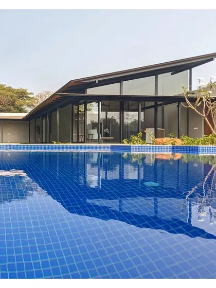 This Alibaug villa, known as V15, uses the pool as a passive cooling device. The simple, ground hugging structure is built with low maintenance Indian materials, designed for seekers of a soulful, natural life.