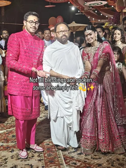 Not all blessings are spoken; some are simply felt. A beautiful portrait of the bride and groom with their Guruji, a moment of peace and sanctity during their destination wedding.