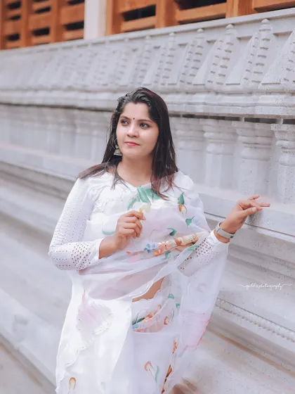 A series of peaceful portraits taken at a temple. The model's white saree contrasts beautifully with the intricate stone architecture, creating a sense of calm and serenity.