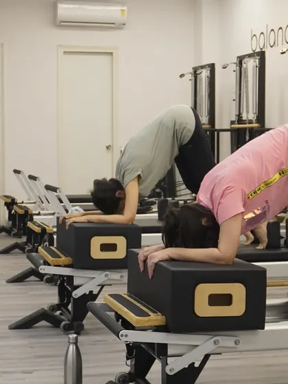 A pike on the reformer box. This move is an intense challenge for the core and shoulders.