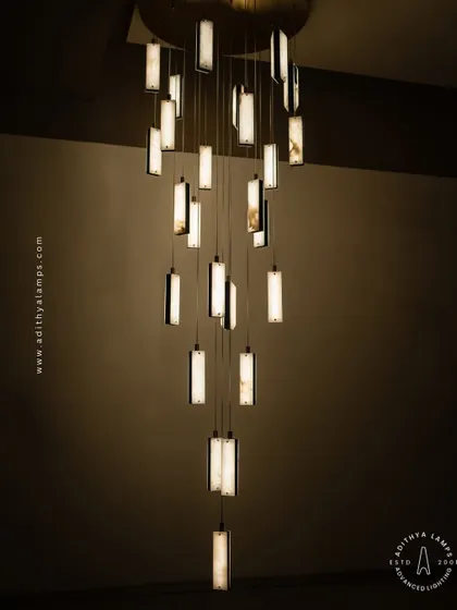 These modern pendants feature a unique combination of translucent marble and stitched leather accents. The warm light glows through the marble, creating a sophisticated and texturally rich fixture for contemporary spaces.