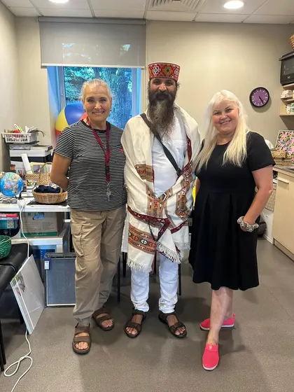 Posing with students in their workspace. It shows how the principles of yoga and mindfulness can be brought into any environment, including our professional lives.