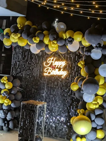 An angled view showing the depth of the balloon arch against the shimmering sequin wall, perfect for night-time celebrations.