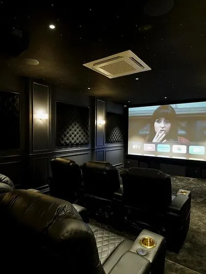 This shot from the side shows the full scope of the Kanchipuram theater, with the screen displaying the user-friendly Apple TV interface, ready for movie night.