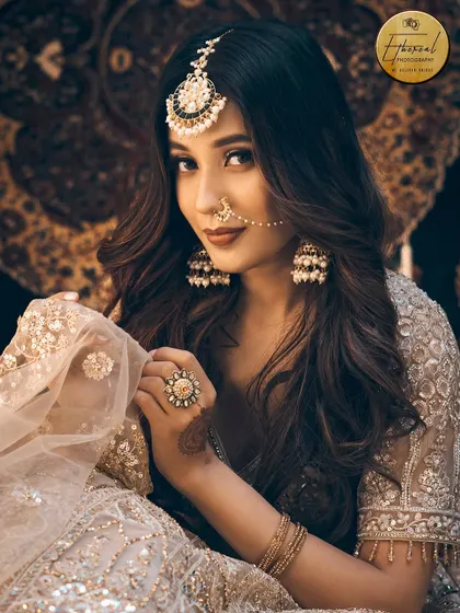 A beautiful portrait where the model glances at the camera, holding her dupatta. This shot feels natural and engaging, perfect for fashion lookbooks.