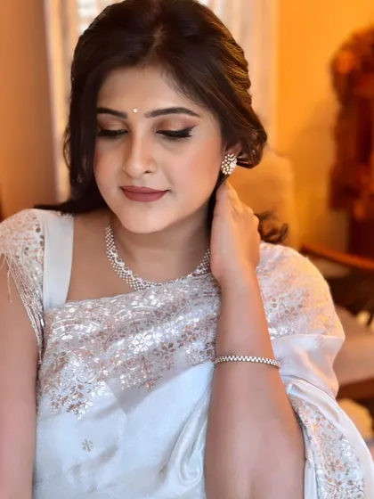 A candid shot showing the soft, blended eye makeup and the overall sophisticated feel of this party look.