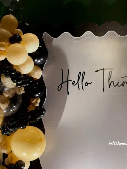 A close-up of the 'Hello Thirty!' backdrop, showing the elegant script and unique wavy edge design. We can create custom backdrops for any theme or milestone.