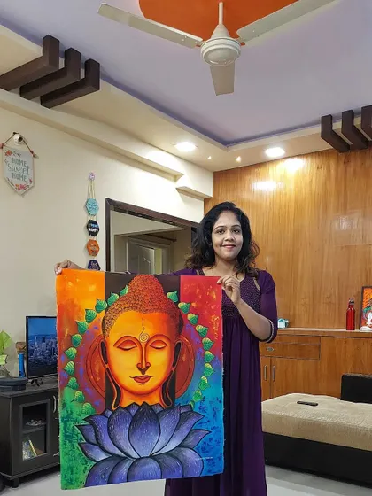I am holding one of my finished Buddha paintings, created to bring a sense of peace and serenity into your home. This large 24x31 inch canvas features vibrant colors and a calming presence, making it a wonderful centerpiece for any room.