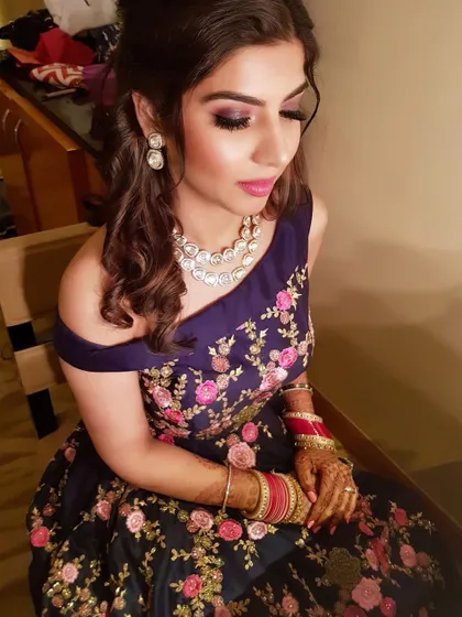 A candid shot capturing the shimmer on her eyelids and the perfect pink lip color.