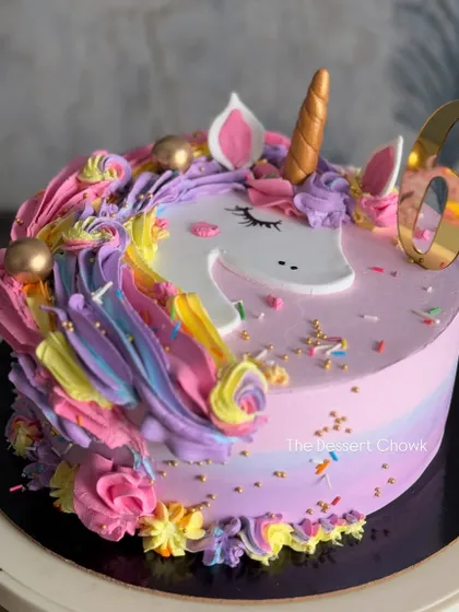 A magical unicorn cake that's always a hit with the little ones. This design features a rainbow of buttercream swirls, a golden horn, and a sprinkle of edible glitter.