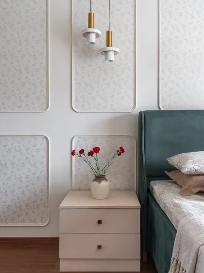 A close-up of the bedside table and wall paneling, showing the harmony of colors and textures in the master bedroom.