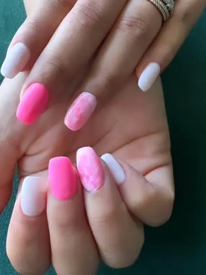 This set showcases a mix of solid hot pink, light pink, and a pink-and-white marbled accent nail. It's a great way to wear different shades and textures within the same color family.
