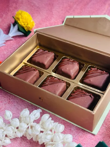 The Nutella Fudge Bites gift box, shown here with traditional Indian flowers, highlighting its suitability for festive gifting during Diwali.
