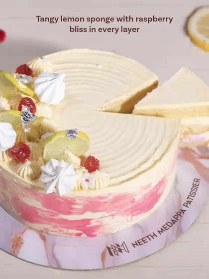 A slice of our Lemon Raspberry Cake, revealing the tangy lemon sponge and raspberry bliss in every layer.