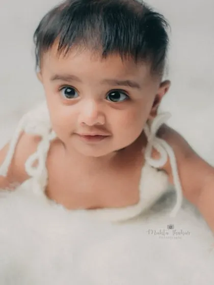 That curious gaze is so captivating. I love capturing these quiet, thoughtful moments during a milestone session.