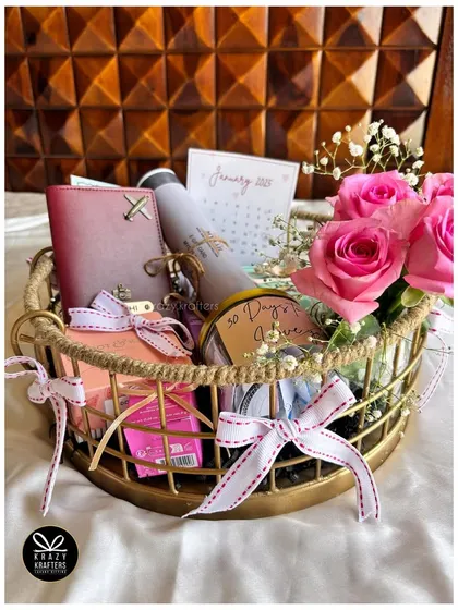 A '30 days to go' countdown hamper, beautifully arranged in a gold wire basket with fresh roses.