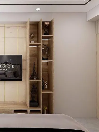 A TV unit designed for a master bedroom in Noida. The wall paneling cleverly conceals the washroom door, and an integrated shelving unit provides space for displaying collectibles.