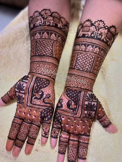 A traditional bridal design featuring majestic elephants on the wrist and graceful peacocks on the palm. This is a classic look for any wedding.