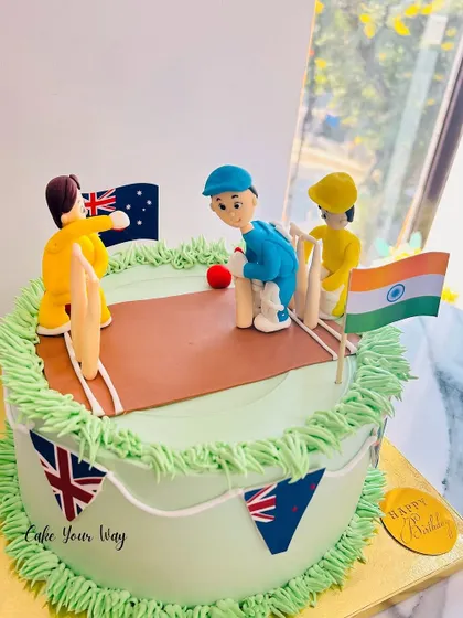 Another angle of the detailed cricket match cake, showing the players and flags.