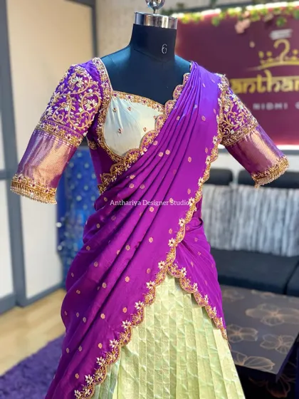 A closer look at the bodice and drape of the mint and purple langa voni. The scalloped gold embroidery on the davani adds a touch of elegance.