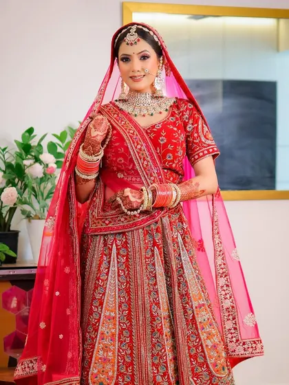 A full-length portrait of the bride in her red lehenga, shot with a Canon R10 and 35mm lens. This shows my versatility with different camera bodies and lenses.