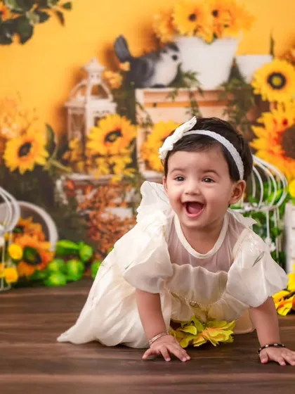 A crawling shot amidst a field of sunflowers. This dynamic photo captures the joy and energy of a one-year-old on the move.