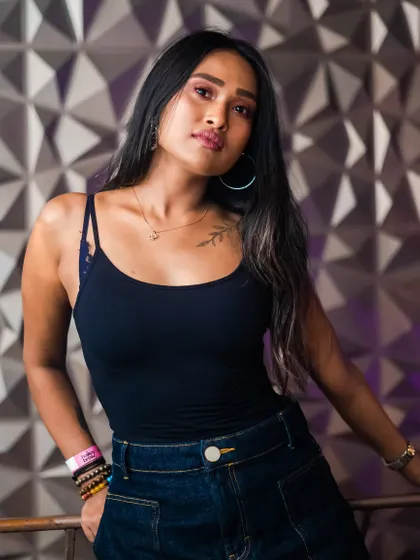 A guest posing against the textured wall, a popular photo spot.