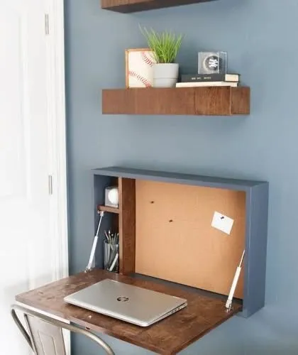 This wall-mounted desk includes a corkboard back panel, making it a perfect compact workstation for any room.