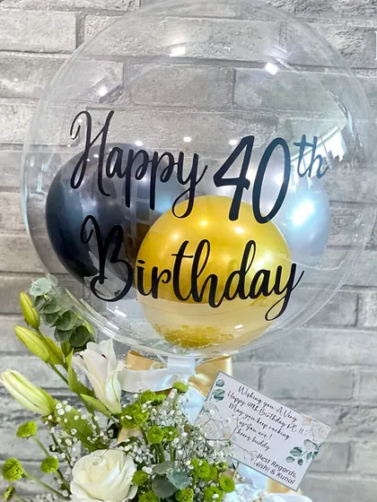 A close-up of the "Happy 40th Birthday" balloon. The combination of black, gold, and silver balloons inside creates a sophisticated and festive look, perfect for a milestone celebration.