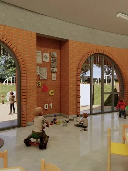 An interior view of a classroom at Urban Gurukul. The large, arched windows connect the indoor learning space directly to the outdoor play area, blurring the lines between inside and out and filling the room with natural light.