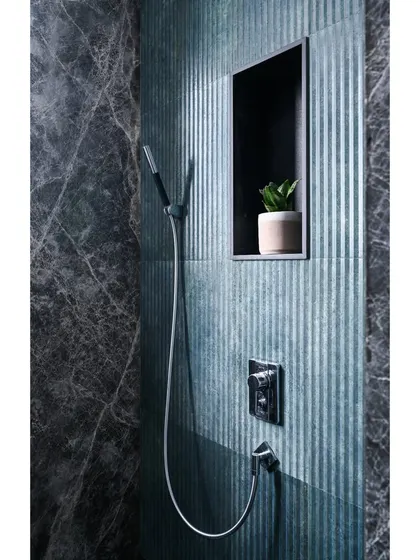 In the shower area of the son's bathroom, we paired the grey marble with striking green ribbed tiles, adding a pop of color and texture.