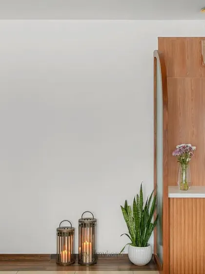 A wider shot of the open wall space, showing its relationship to the foyer and kitchen entrance.