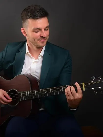 A musician's passion captured in a portrait. This shot, showing a professional playing guitar, is perfect for an artist's profile or website.
