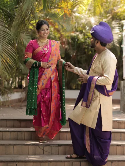 A playful and happy moment between the traditionally dressed couple.
